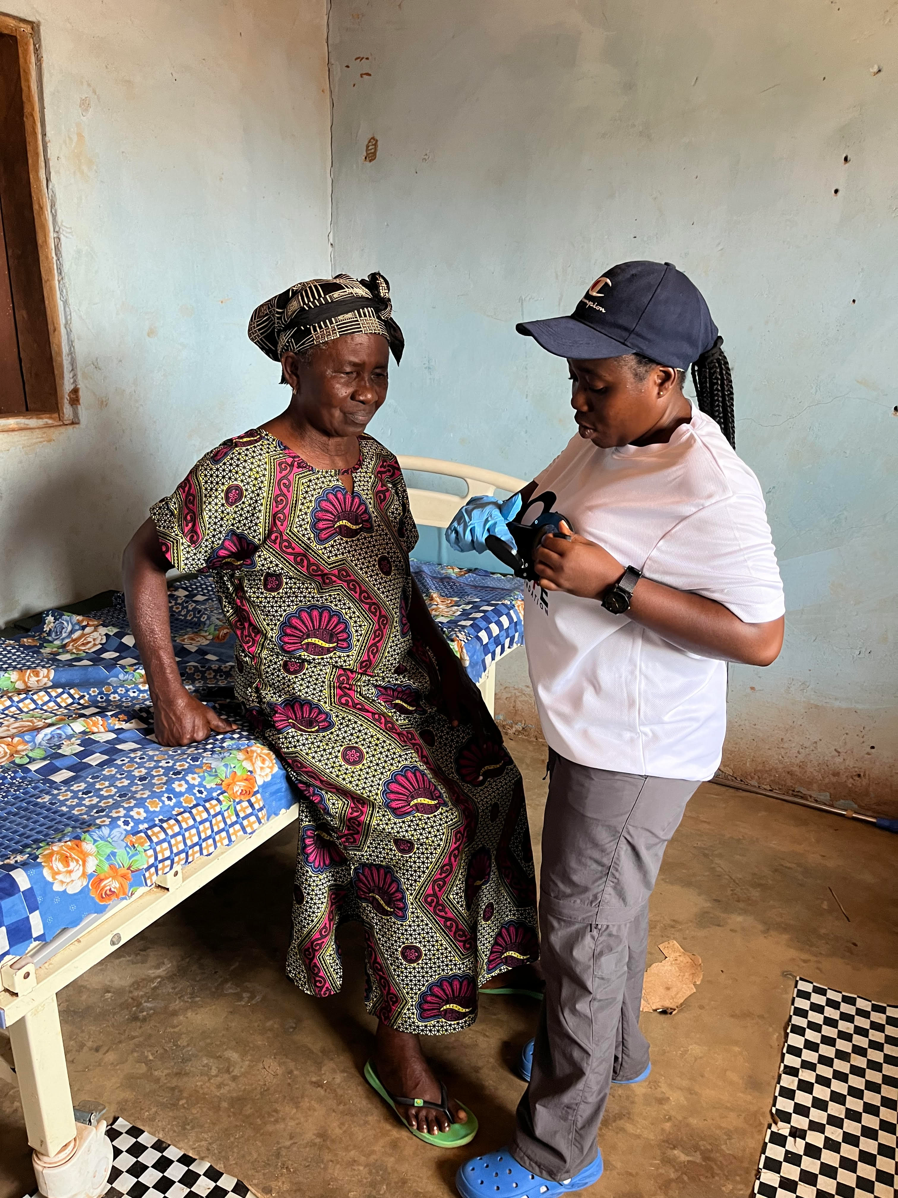 Healthcare worker demonstrating MiraScope® breast examination technique in Ghana